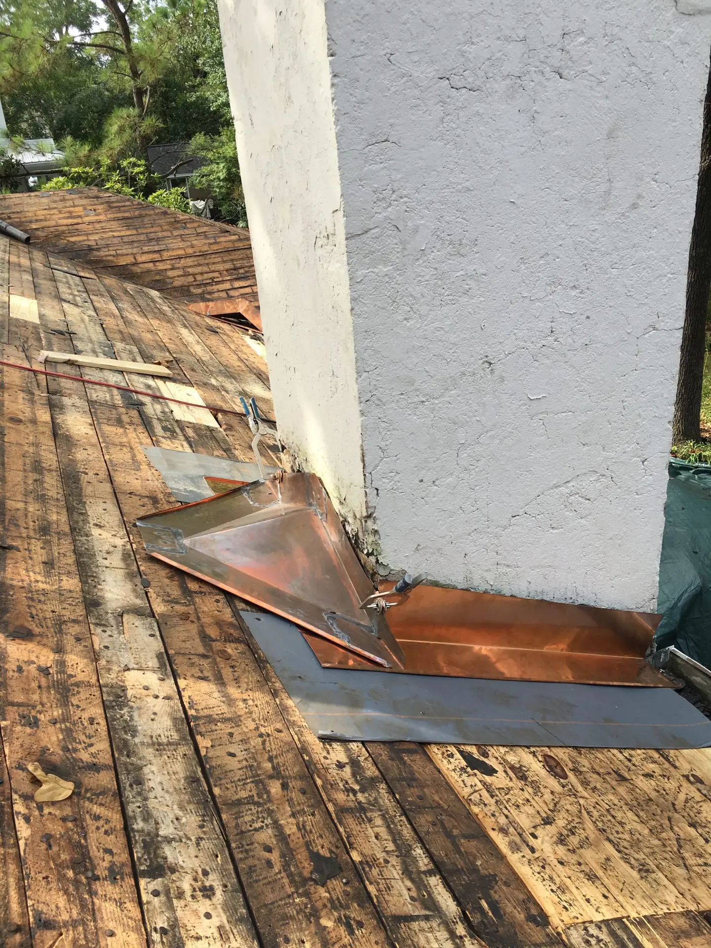 a bare roof ready for a new roof installation. The rusted flashing shows why you should remove old shingles before installing a new roof.